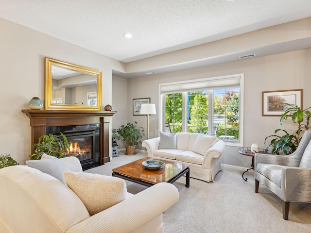 carpeted living room with a textured ceiling