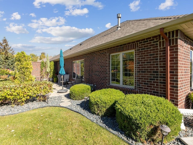 view of home's exterior with a patio and a yard