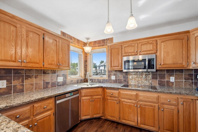 kitchen featuring sink, stainless steel appliances, tasteful backsplash, dark hardwood / wood-style flooring, and decorative light fixtures