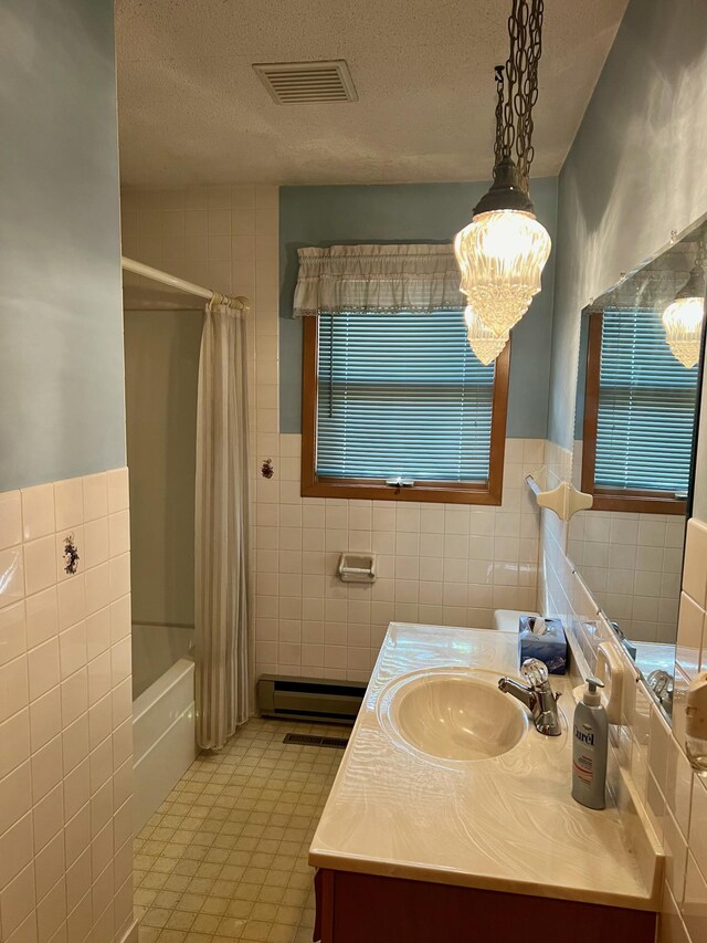 bathroom with shower / bath combination with curtain, tile walls, and vanity