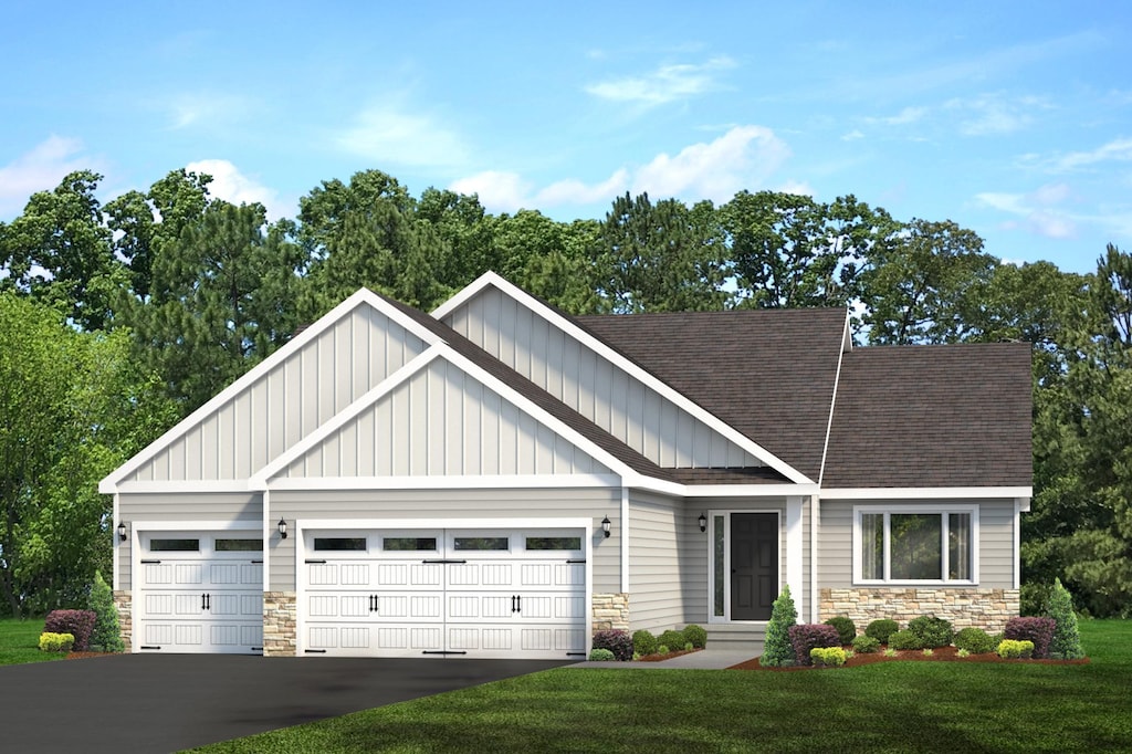 craftsman house with a garage and a front lawn