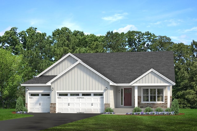 view of front of home with a front yard and a garage