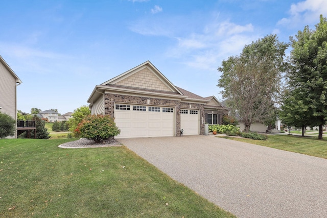 view of front of property with a garage, a front lawn, and driveway