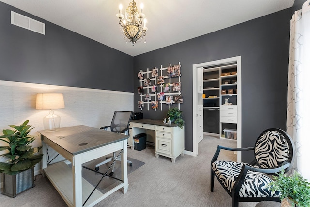 home office with visible vents, light carpet, an inviting chandelier, and a wainscoted wall