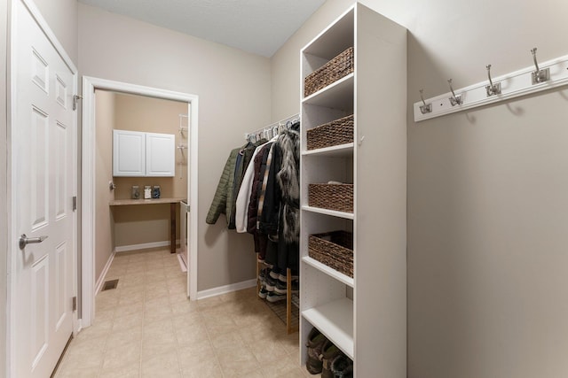 spacious closet featuring visible vents