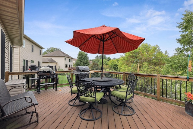 wooden terrace featuring grilling area and outdoor dining area