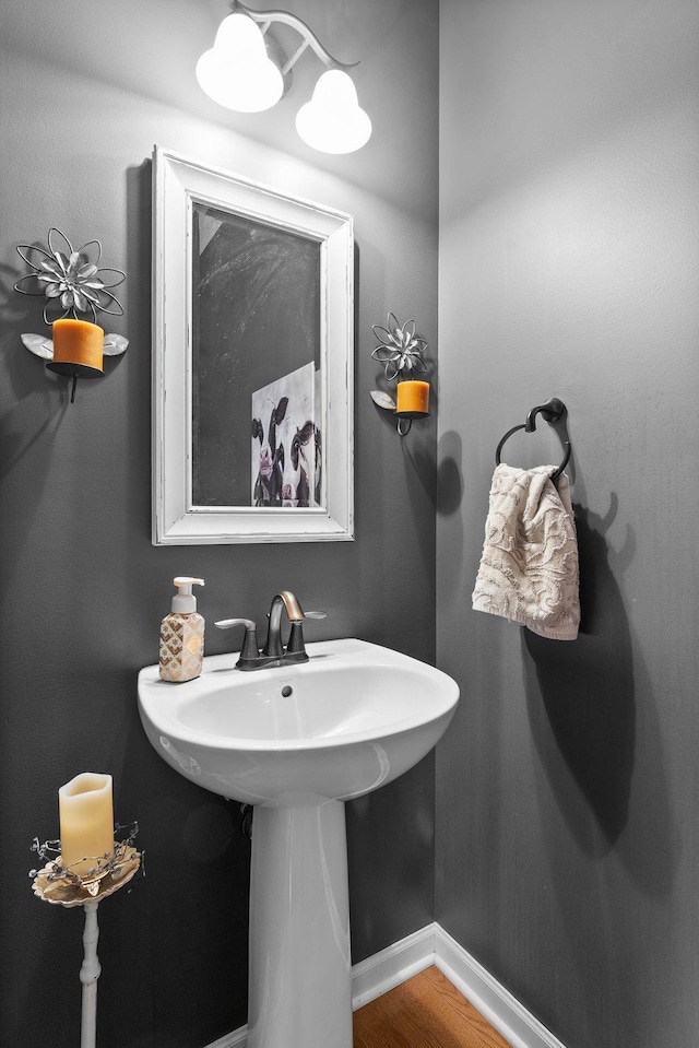 bathroom featuring wood finished floors and baseboards