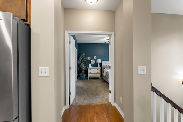 hall featuring baseboards and light wood finished floors