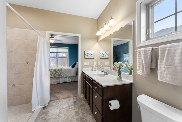 ensuite bathroom with tiled shower, toilet, ensuite bath, and vanity