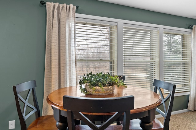 dining room with baseboards and carpet flooring