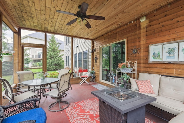 sunroom / solarium with wooden ceiling and ceiling fan