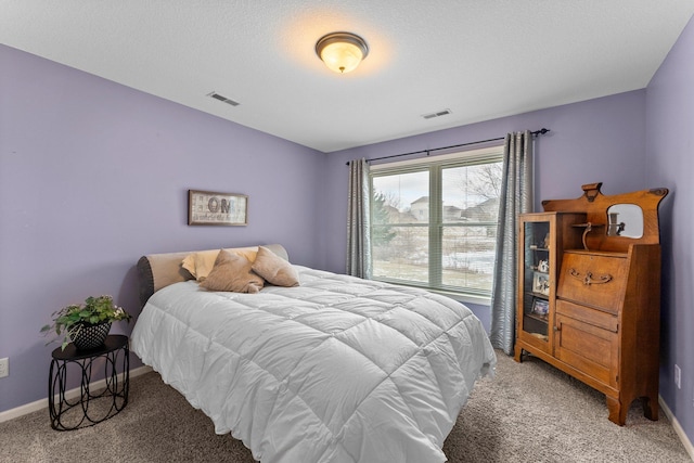 bedroom with visible vents, light colored carpet, and baseboards