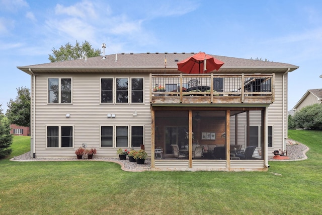 back of property with a yard, a sunroom, and a wooden deck