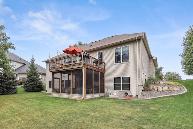 rear view of house featuring a yard and a sunroom