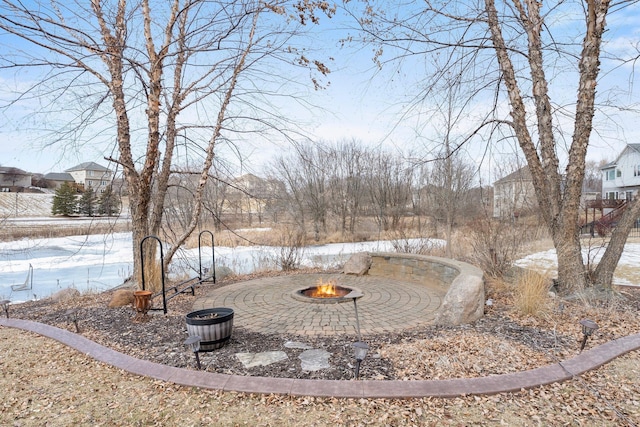 snowy yard featuring an outdoor fire pit