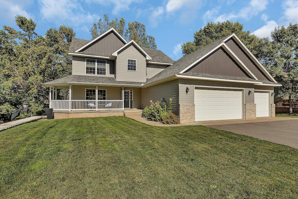 craftsman-style house with a front yard, a garage, and a porch