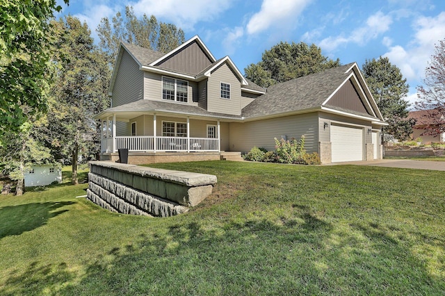 view of front of house with a front yard, a garage, and covered porch