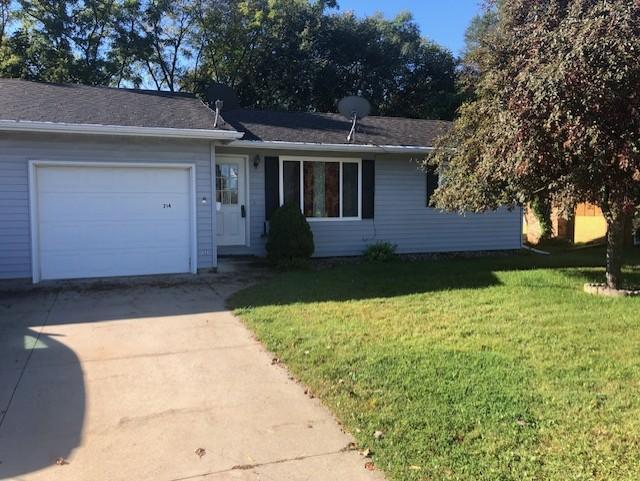 ranch-style home with a front lawn and a garage