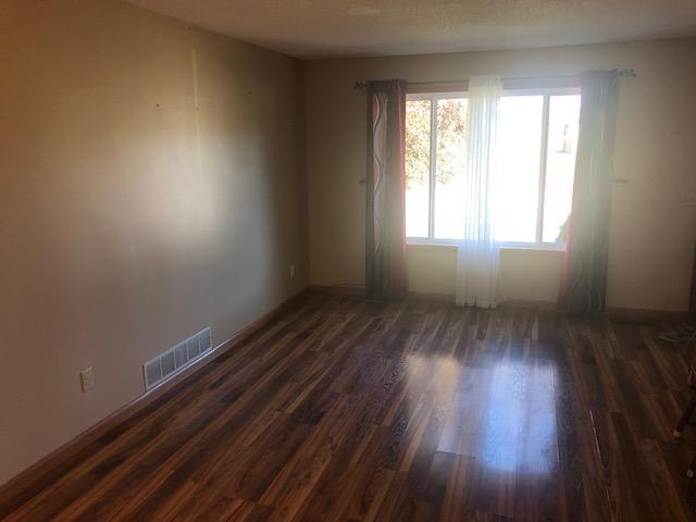 unfurnished room with dark hardwood / wood-style floors