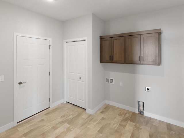 laundry area featuring hookup for a washing machine, cabinets, hookup for an electric dryer, and light hardwood / wood-style floors