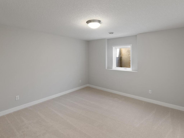 unfurnished room featuring carpet floors and a textured ceiling