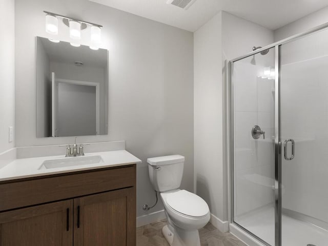 bathroom featuring a shower with door, vanity, and toilet