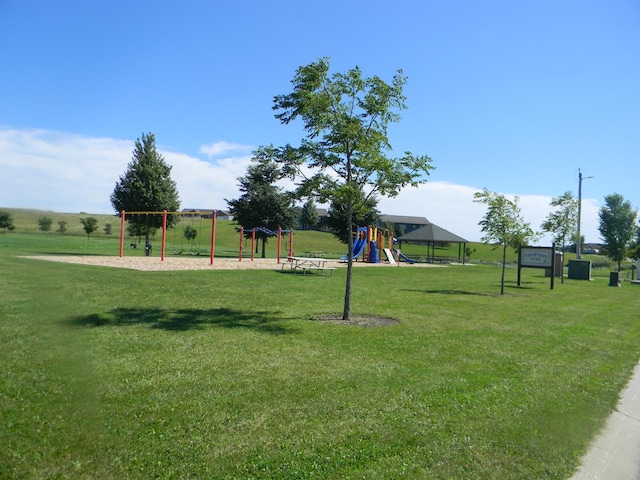 view of property's community with a playground and a lawn