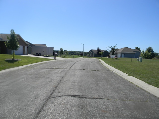 view of road featuring street lighting and curbs