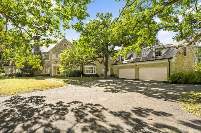 view of front of home with a front lawn and a garage