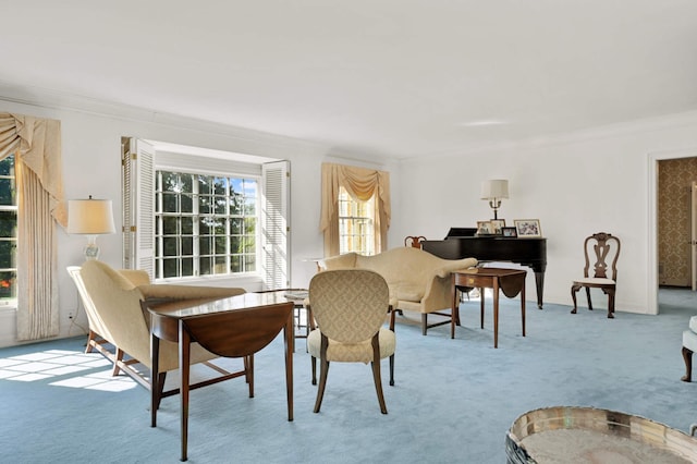 carpeted dining room featuring crown molding