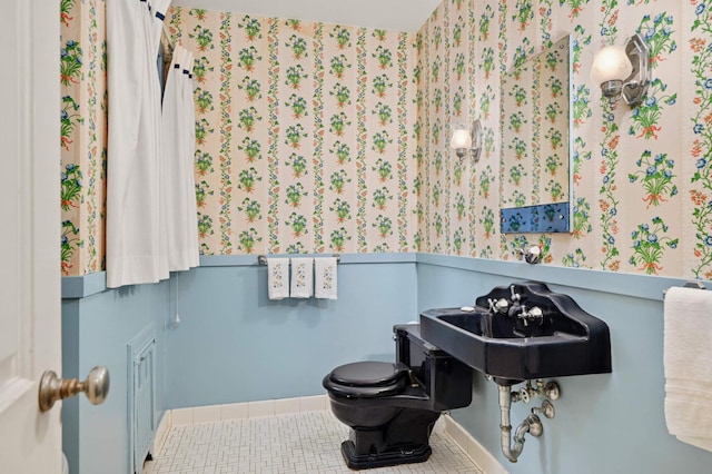 bathroom featuring toilet and tile patterned floors