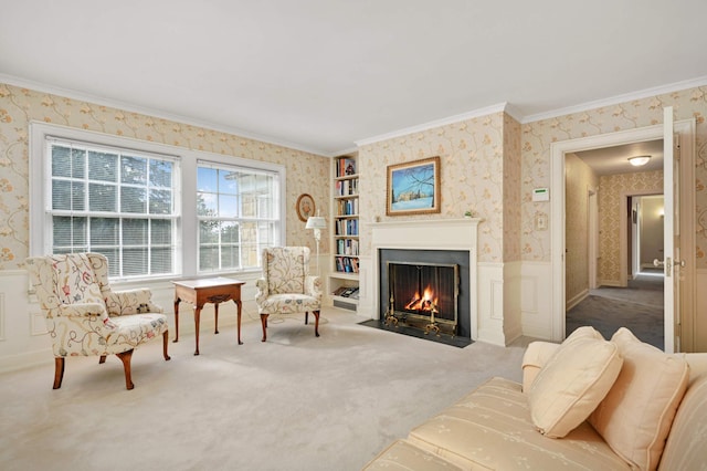 sitting room featuring crown molding and carpet