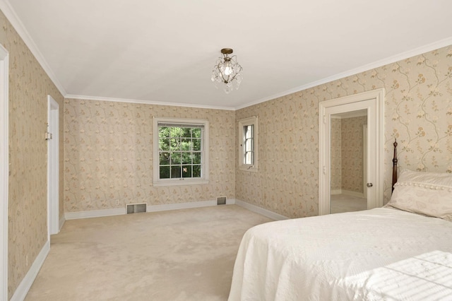 carpeted bedroom with ornamental molding and a chandelier