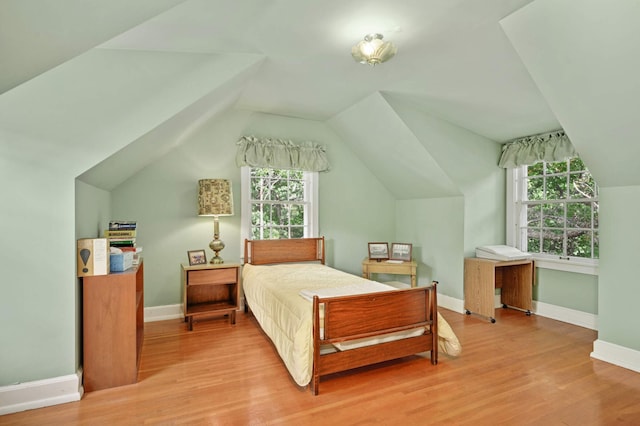 bedroom featuring vaulted ceiling and light hardwood / wood-style floors