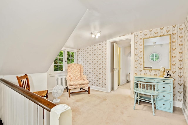 sitting room with carpet, vaulted ceiling, and radiator heating unit