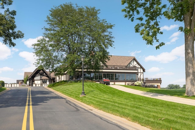 tudor-style house with a front yard