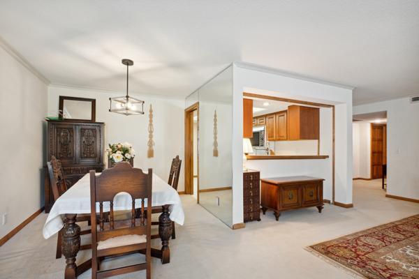 dining space with ornamental molding and an inviting chandelier