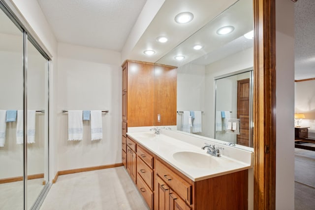 bathroom featuring a textured ceiling and vanity