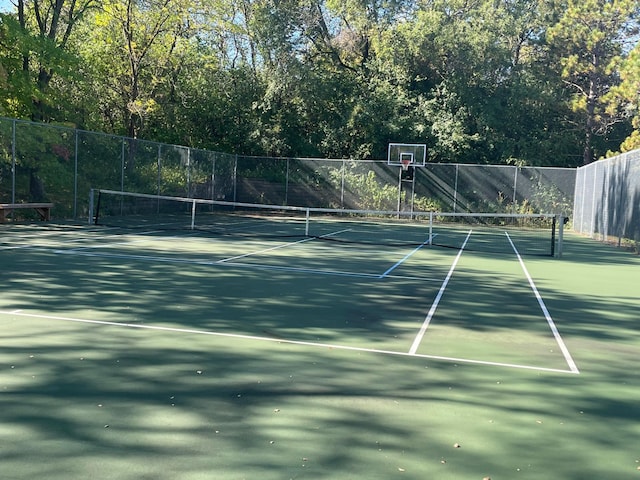 view of tennis court featuring basketball court