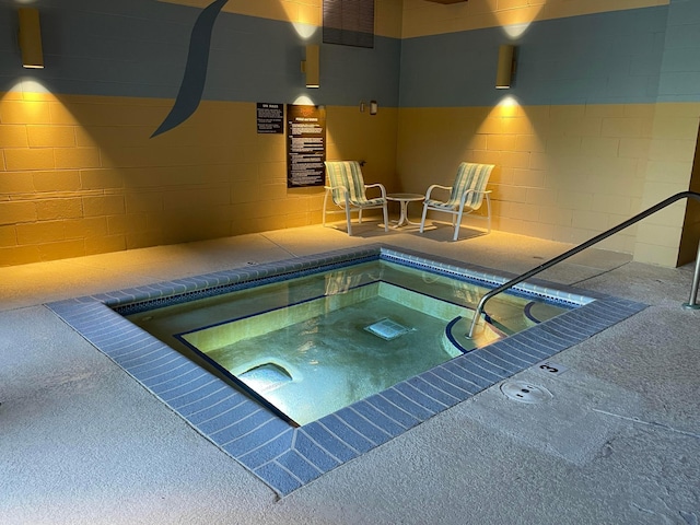 view of pool with an indoor hot tub