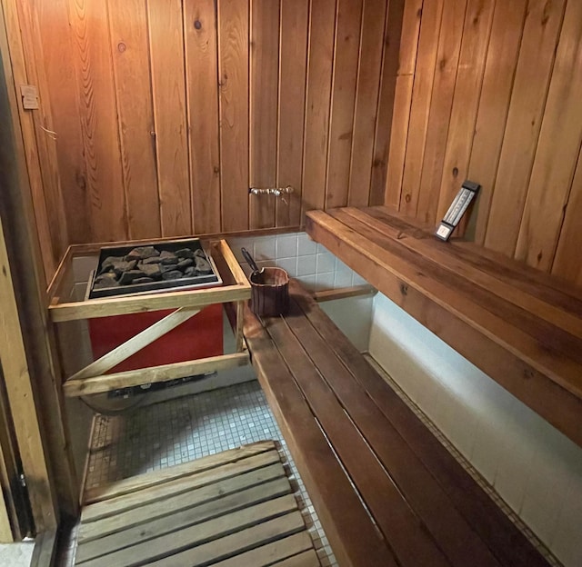 view of sauna / steam room with wood walls and tile patterned floors