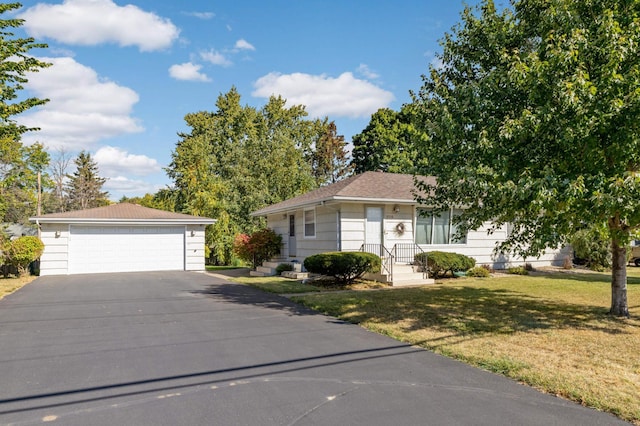 single story home featuring a garage and a front yard