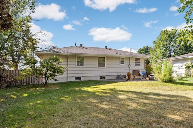 rear view of house featuring a lawn