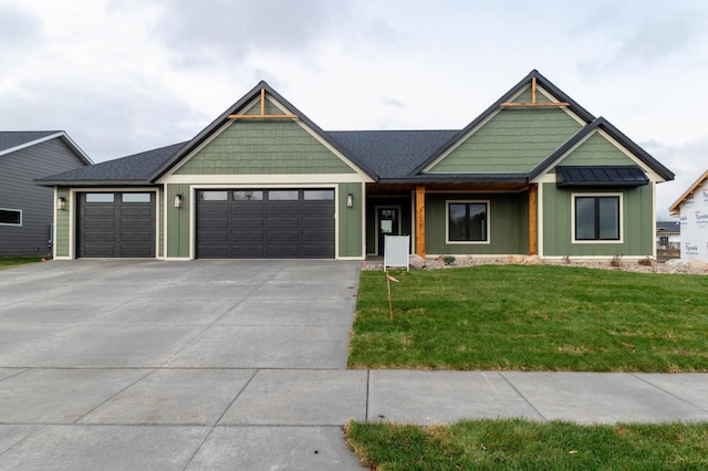 view of front of house featuring an attached garage, board and batten siding, a front yard, and concrete driveway