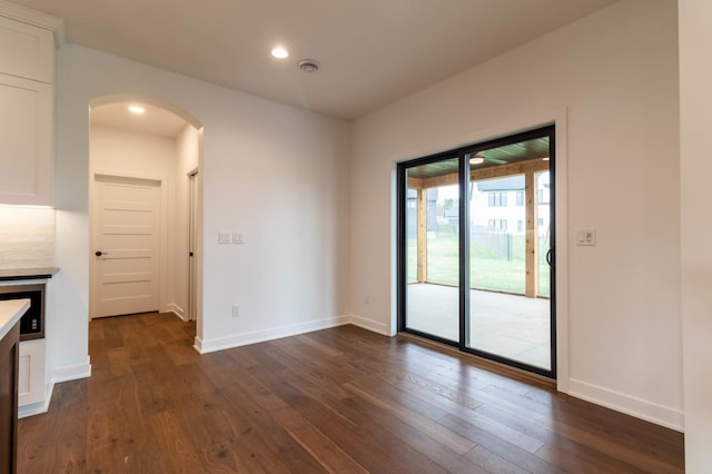 unfurnished dining area featuring dark hardwood / wood-style flooring