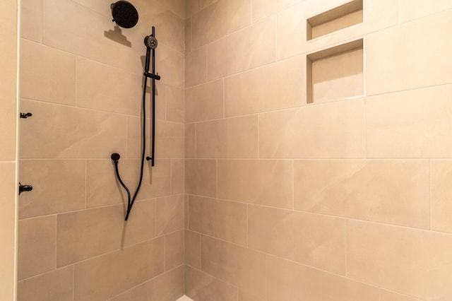 bathroom with a tile shower