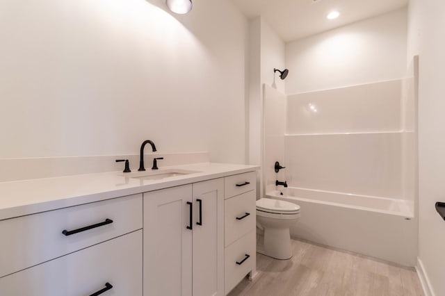 full bathroom with toilet, vanity, hardwood / wood-style flooring, and  shower combination