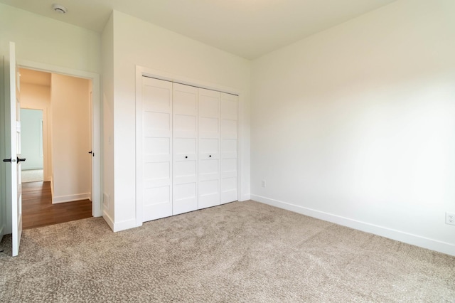 unfurnished bedroom with a closet and carpet floors