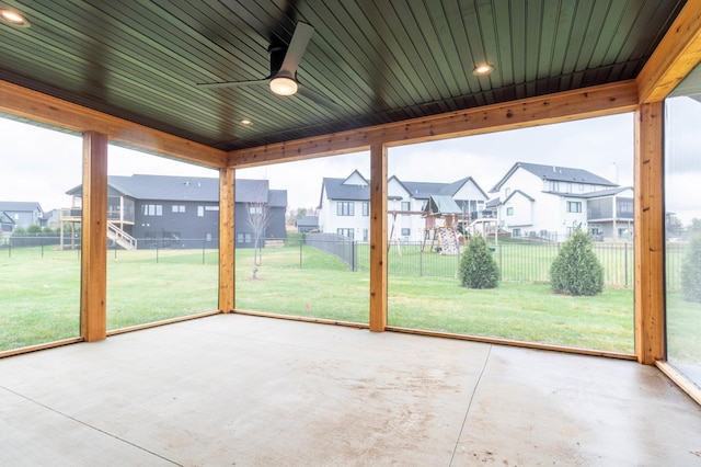 unfurnished sunroom with ceiling fan and wood ceiling