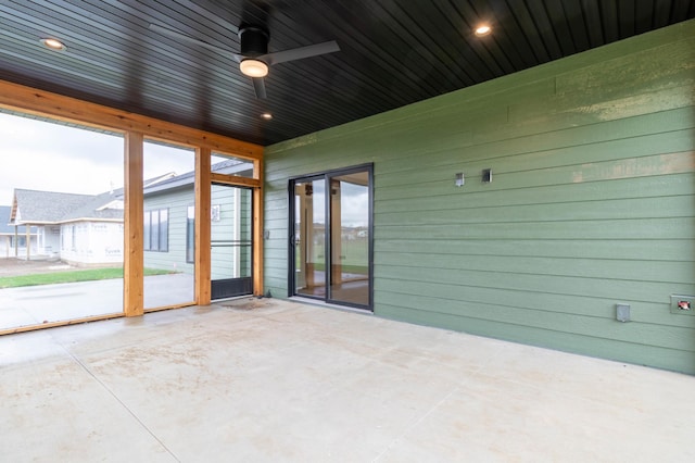 unfurnished sunroom featuring wooden ceiling and ceiling fan